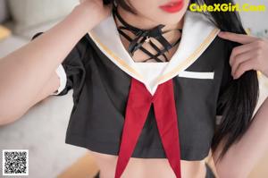 A woman in a school uniform posing for the camera.