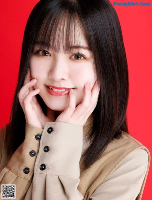 A woman with long black hair and bangs posing for a picture.