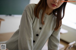 A woman in a striped shirt is posing for a picture.