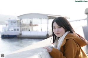 A woman in a white bikini sitting in a boat.