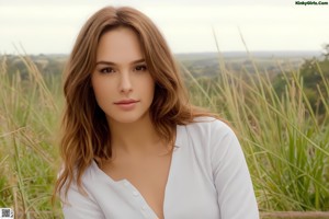 A woman in a pink bra is posing for the camera.