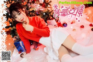 A woman in a red sweater is posing for a magazine cover.