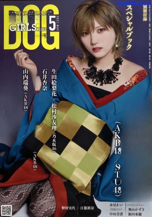 A woman in a blue kimono is posing for a picture.