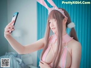 A woman in a pink bunny costume posing for a picture.