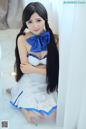 A woman with long black hair wearing a maid outfit.