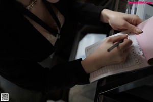 A woman is using a printer in an office.