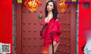 A woman in a red lingerie sitting on a red chair.