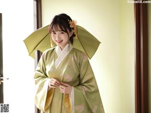 A woman in a kimono sitting on a window sill.