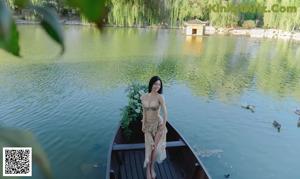 a woman in a bikini sitting on a bench