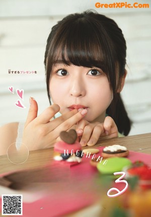 A magazine with a picture of a girl in a red sweater.
