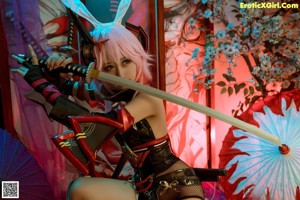 A woman in a bunny costume holding a sword.