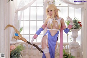 A woman dressed as a princess holding a sword.
